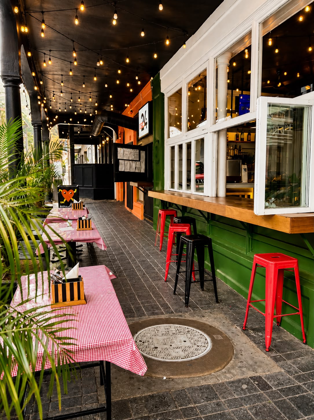 Pavement seating with festoon lights and gingham tables on Long Street