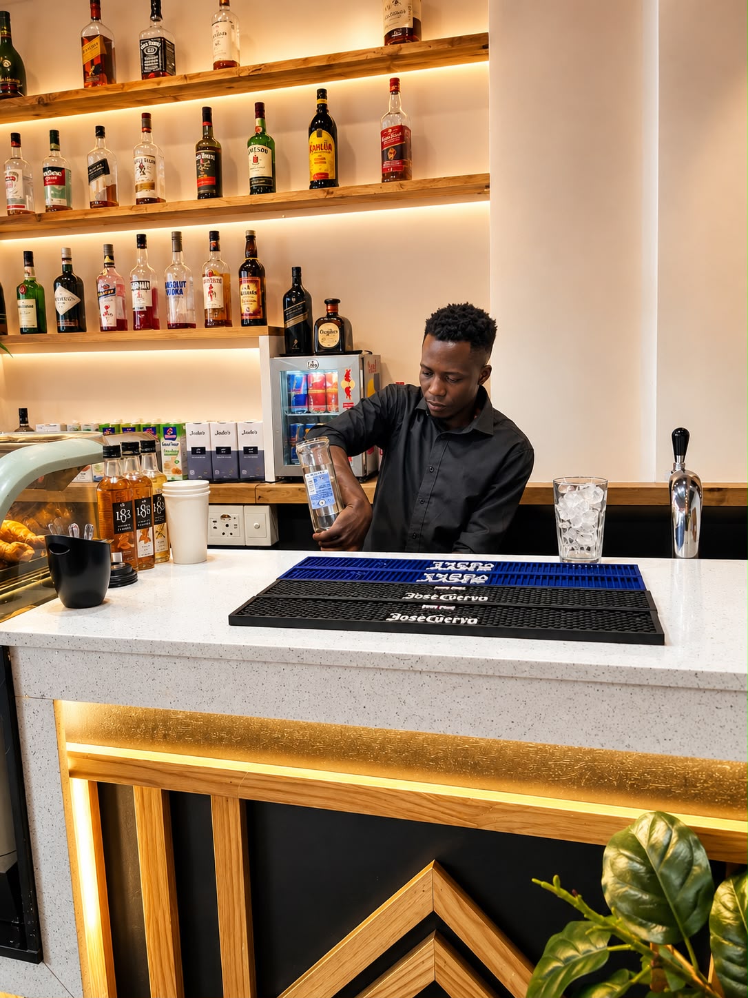 Bartender mixing a drink behind the Lola's bar