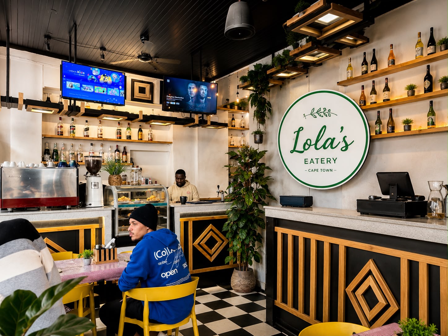 Lola's Eatery dining room with the signature sign, checkerboard floor and bar