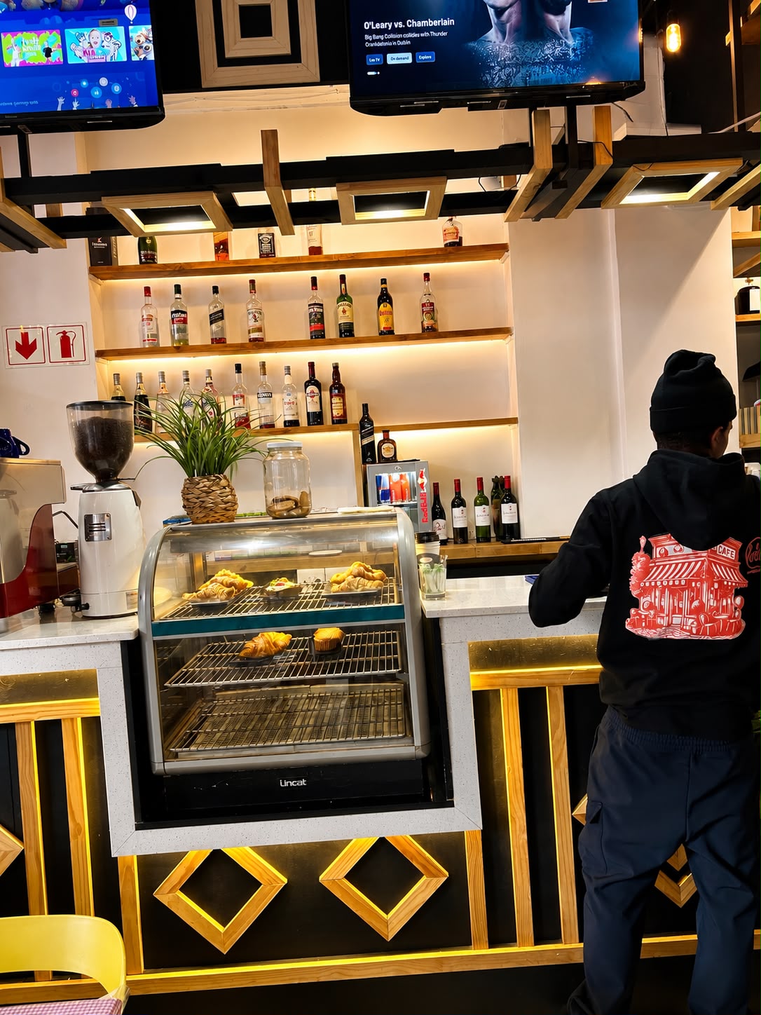 Barista pouring latte art at Lola's Eatery